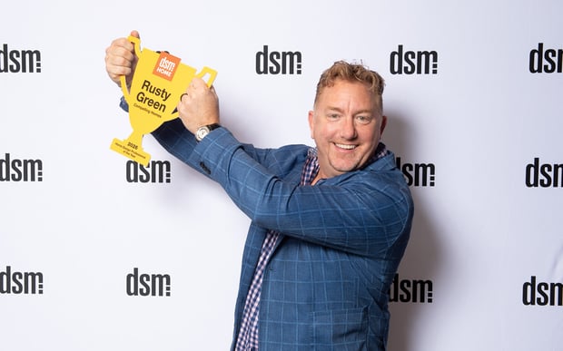Rusty Green, owner of Compelling Homes, accepting the 2026 dsm Magazine Design Professional of the Year award