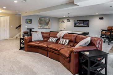 Parlor Setting With Leather Seats In A Basement | Compelling Homes