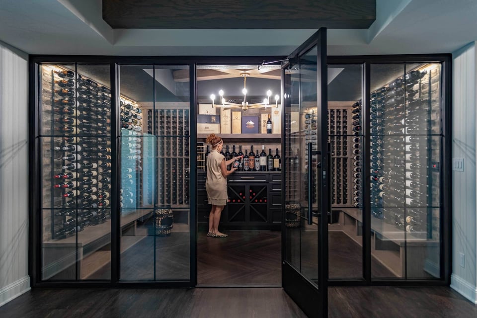 Walk-In Wine Cellar With Enclosed Glass Doors and Stocked Lines