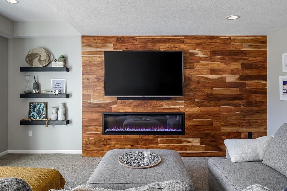 Basement Remodel Hardwood Flooring Accent Wall with Electric Built-In Fireplace and Floating Shelves Lots of Natural Light _ Compelling Homes Remodeling & Design
