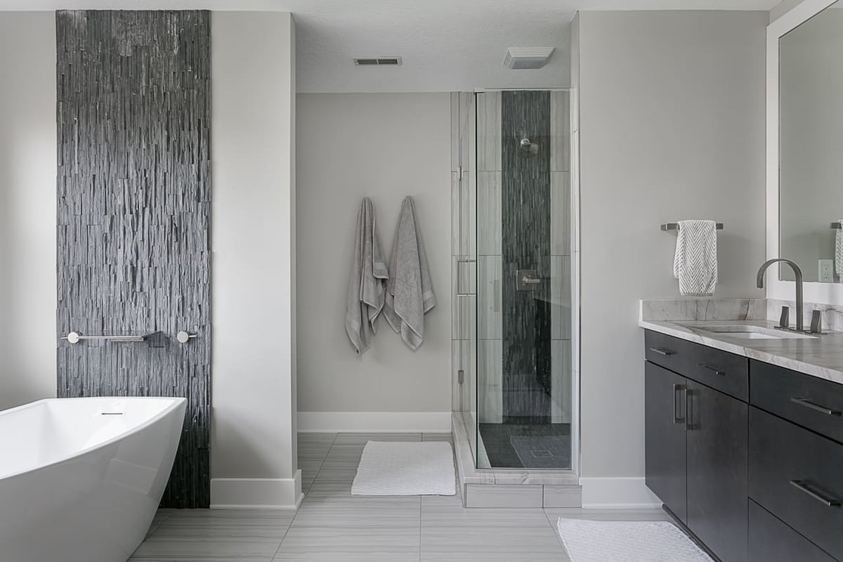 Contemporary bathroom with freestanding soaking tub remodeled by Compelling Homes in Des Moines