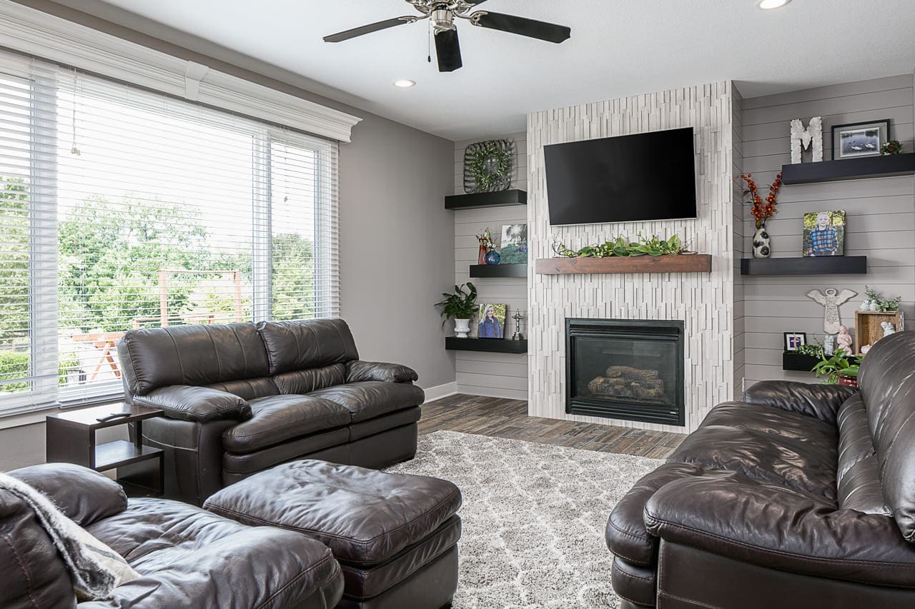 After Living Room Firepalcw with White Vertical Stones | Compelling Homes