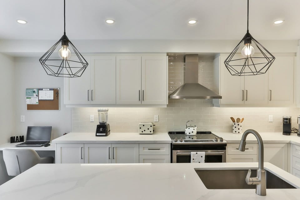 Light fixtures under kitchen cabinets function both as task lighting and accent lighting