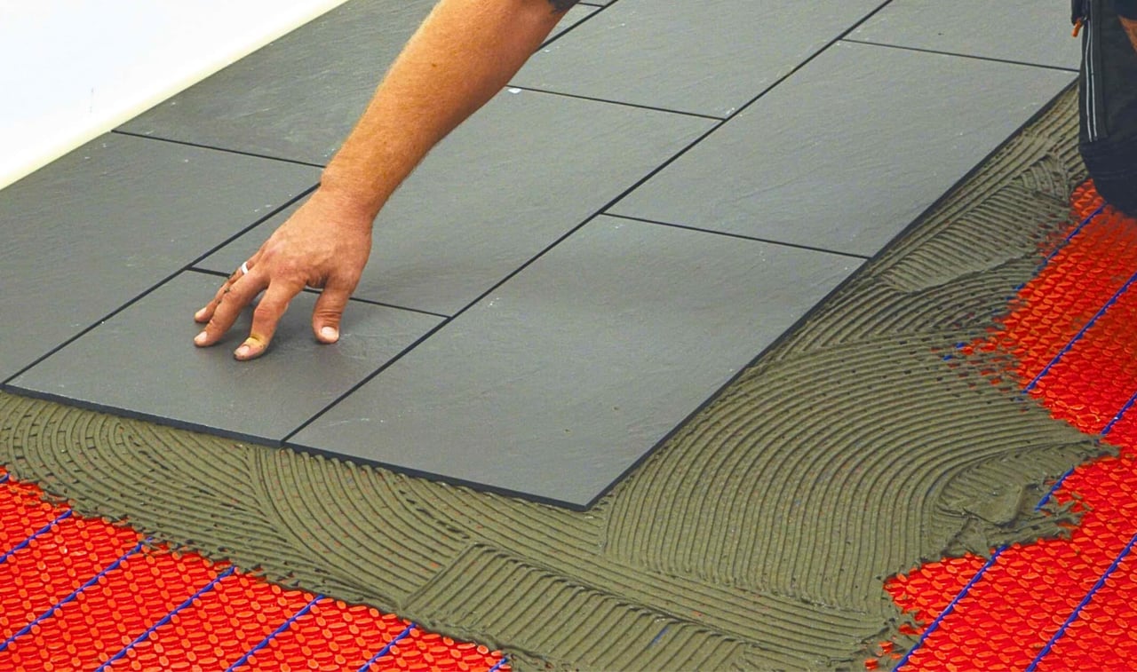 Electric heated floor been plastered by concrete and tiles