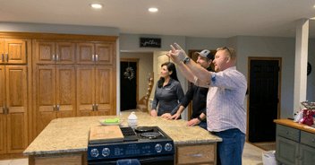 design-build contractor meeting with clients in their kitchen to discuss remodeling
