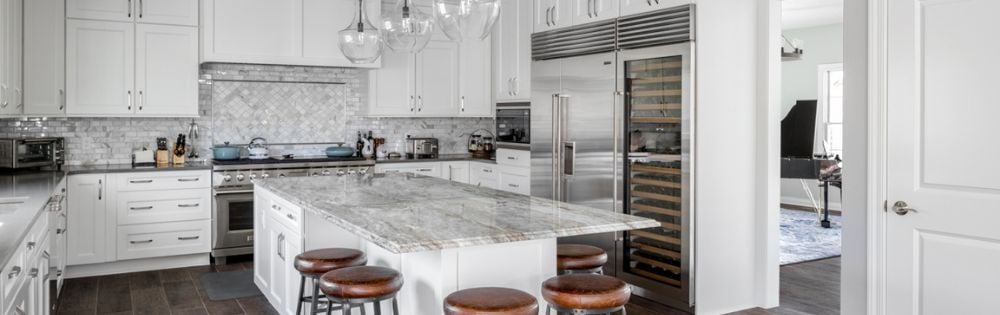 Column Refrigeration in a Sleek Kitchen Remodel with Lots of Natural Stone | Compelling Homes