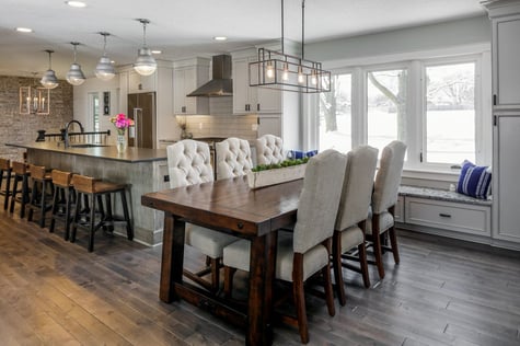 Kitchen Remodel Open Concept Kitchen with Large Eat-In Island and Dining with Large Window Bench Modern Farmhouse Light Fixture and Stone Accent Wall | Compelling Homes