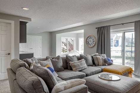 Basement Remodel Natural Light Sliding Doors Overlooking Backyard with Custom Walk-Up Bar | Compelling Homes Remodeling & Design