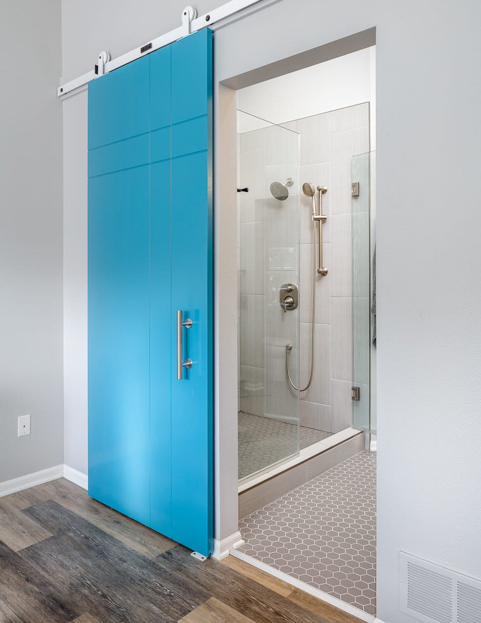 Full-Home Remodel Bedroom with Turquoise Sliding Door into Modern Bathroom