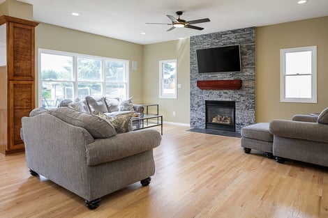 Full-Home Remodel Living Room with Stone Accent Wall Mantlepiece and Fireplace Open Floor Concept