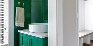 Beautiful Lush Green Hall Bath with Standalone Sink | Compelling Homes