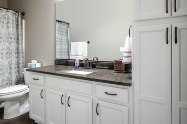 A white vanity in a small 5x7 bathroom