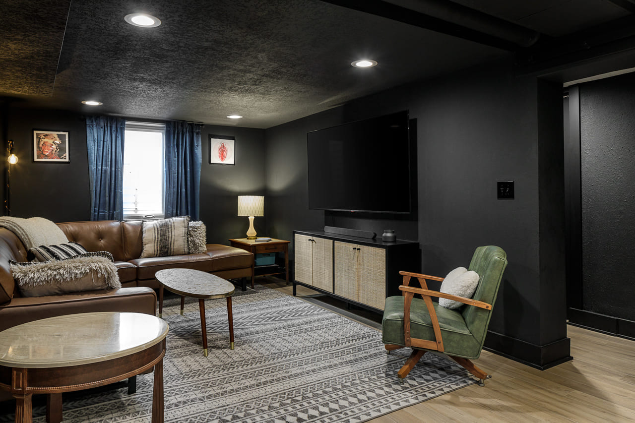 Black Painted Basement with Light Wood Flooring | Compellling Homes