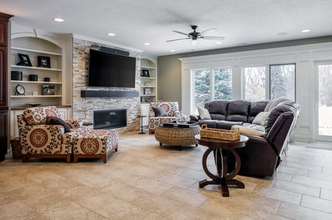 Elegant Walk Out Basement with Stone TV Wall and Heated Flooring | Compelling Homes Des Moines, IA