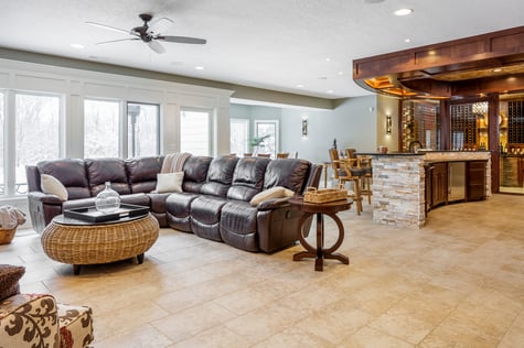 Elegant Walk Out Basement with Wine Cellar and Custom Bar with Natural Light | Compelling Homes Des Moines, IA