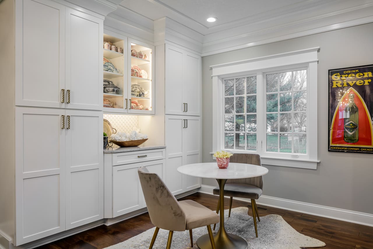 Beautiful Sitting Area Off of Kitchen Remodel with Built In Cabinet Storage and Handmade Custom Crown Molding Accents | Compelling Homes Design-Build Experts in Des Moines, IA