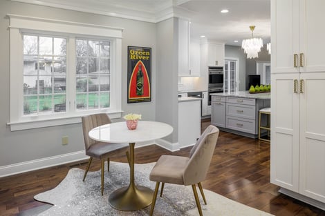 Sitting Area Looking Into Elegant Kitchen with Quartzite Countertops and Beautiful Accent Lighting | Compelling Homes Design-Build Experts in Des Moines, IA