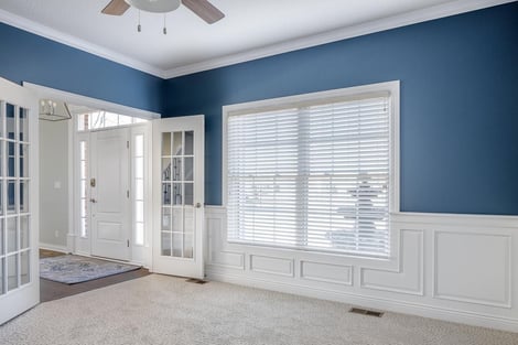 Timeless Living Area with Cool Blue Walls by Compelling Homes