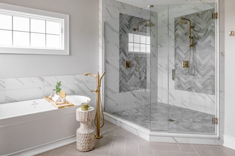 Spacious Walk In Glass Shower with Double Matte Gold Shower Heads and Standalone Tub | Compelling Homes Remodel + Design