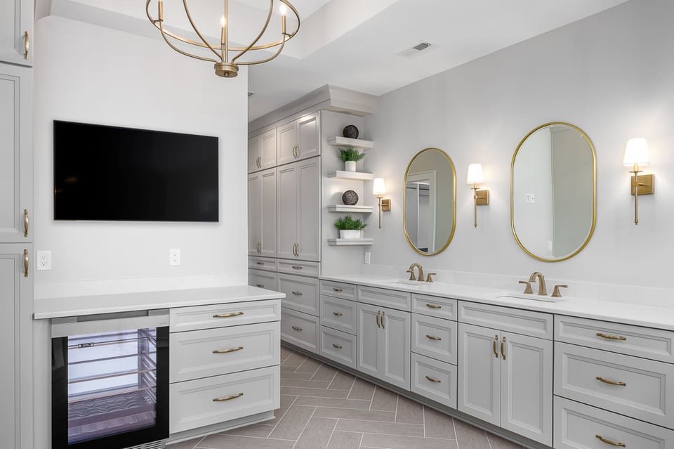 Stunning Primary Bathroom with Double Sinks and Massive Amounts of Storage Featuring a TV and Refrigeration Area | Compelling Homes Remodel + Design