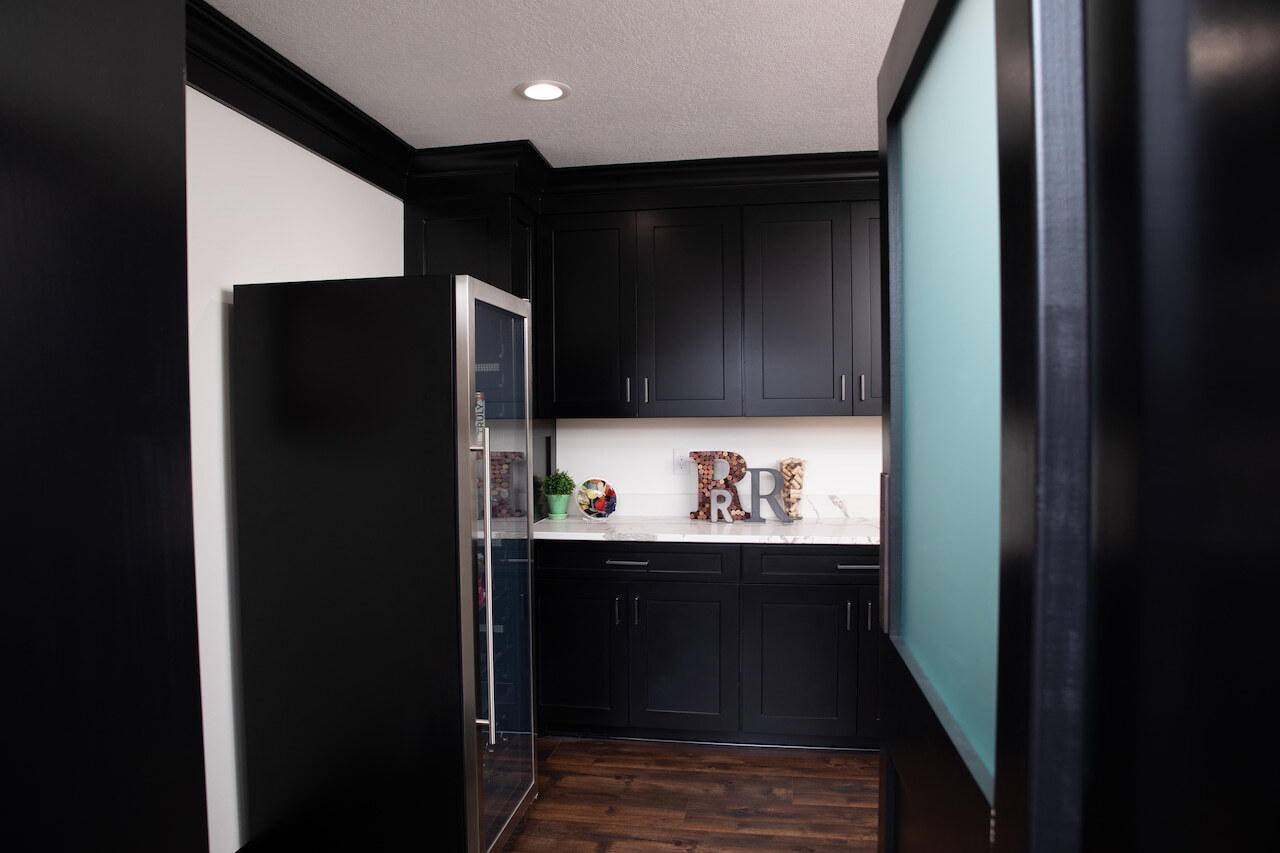 Kitchenette with a chiller in Ross basement by Compelling Homes