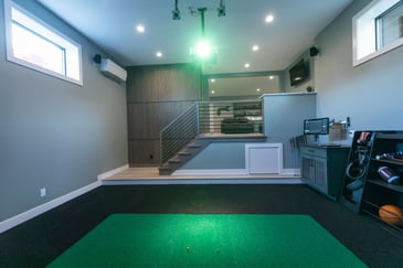 A game stimulator setup in an added room by Compelling Homes