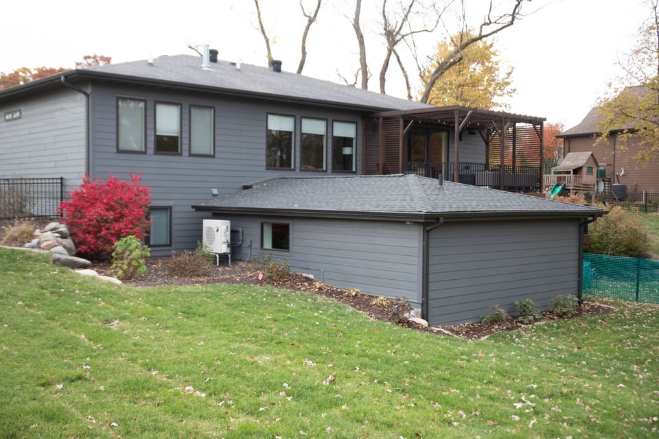 A house built in Eldridge, Iowa with an extended basement and grass field