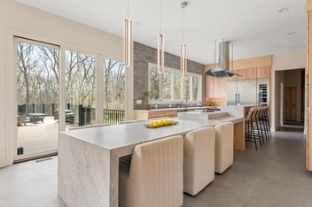 A luxury kitchen with quartz countertop and kitchen stools