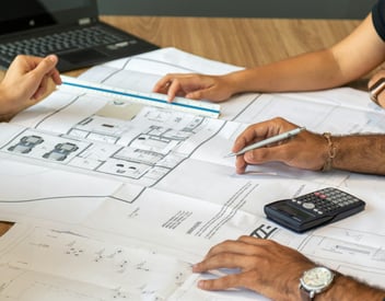 home remodeling contractors at a table with a client