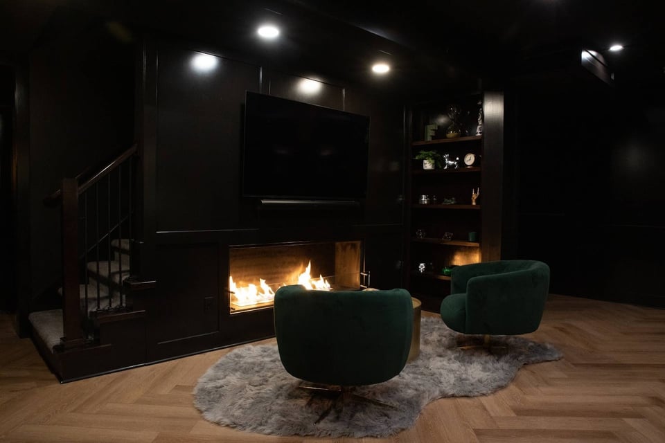Soft in drinking area near a fireplace in a moody basement