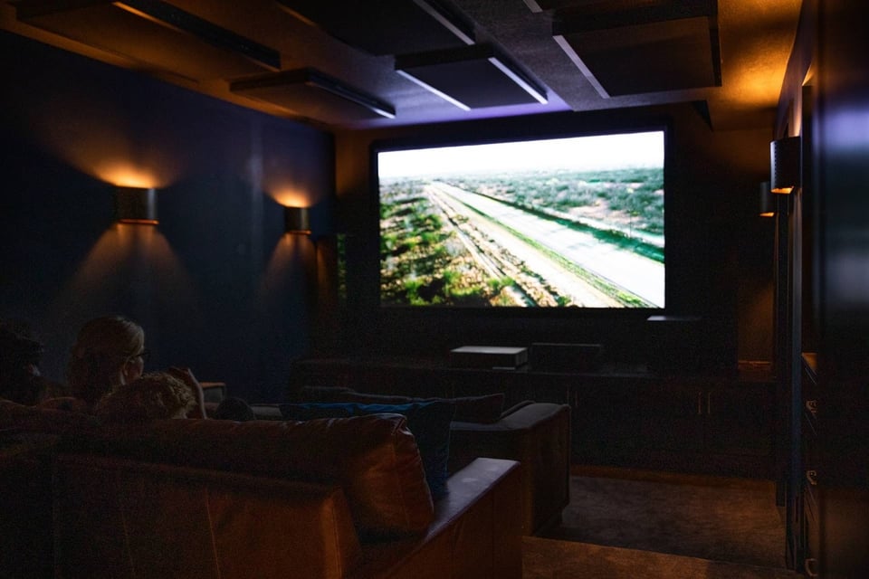 Moody cinema room in a basement with large screen projection