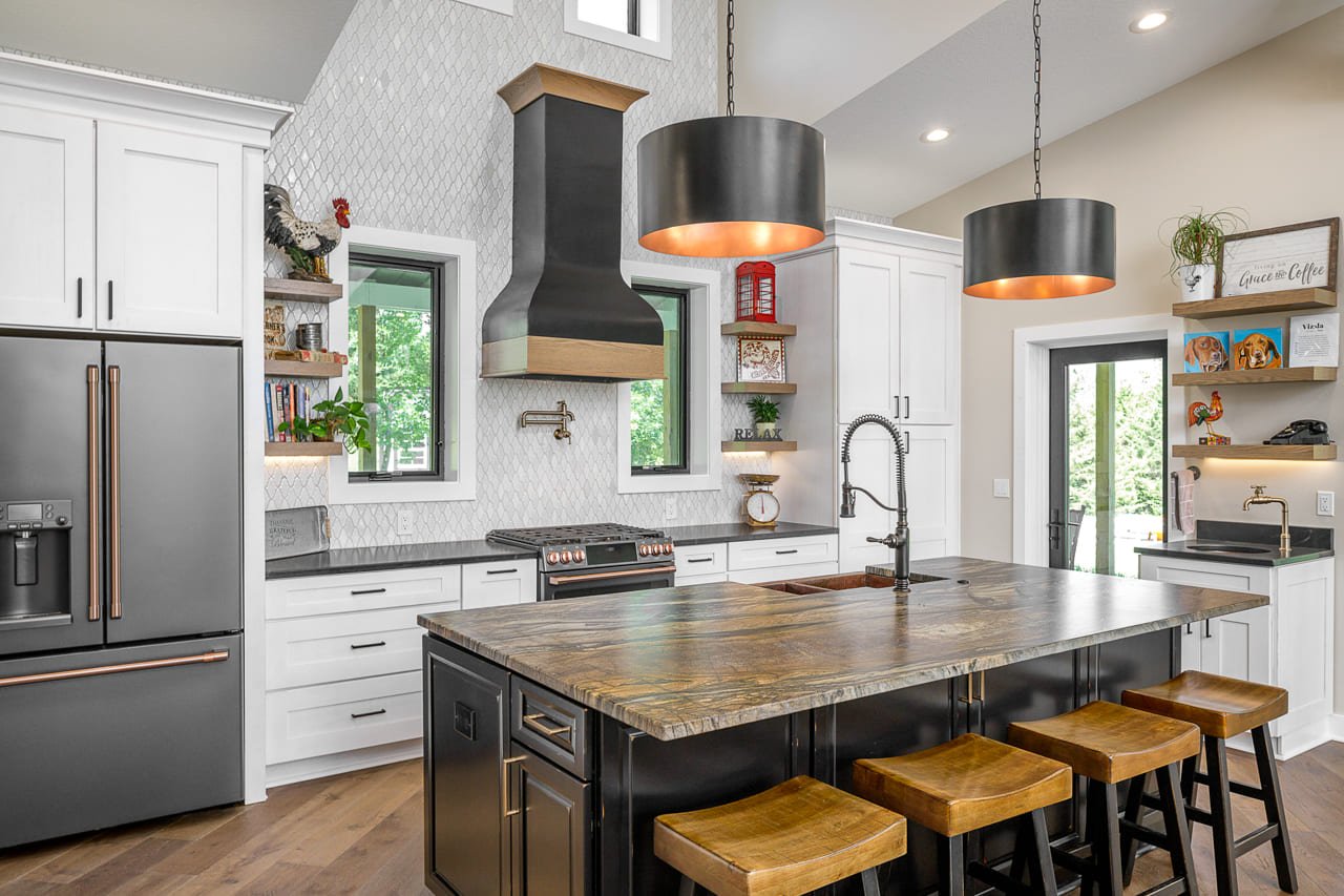 Bright Yet Industrial Kitchen featuring Counter to Ceiling Arabesque Backsplash and Pot Filler and Eat-in Island with Prep Sink | Compelling Homes Remodeling + Design