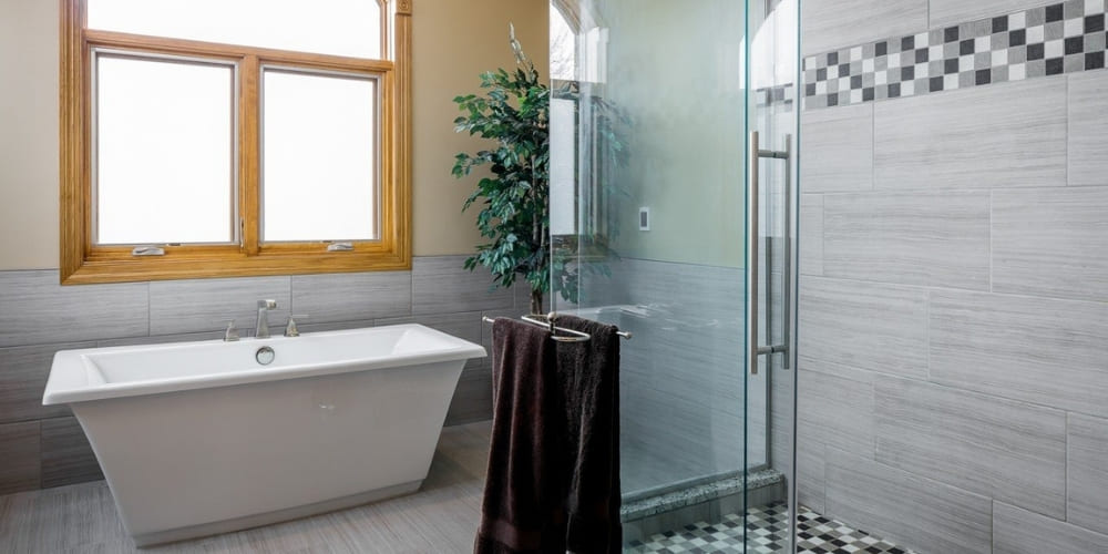 How Much Does a Bathroom Remodel Cost in Des Moines_ _ Freestanding Tub and Walk-In Glass Shower in Modern Bathroom _ Compelling Homes, Des Moines, IA