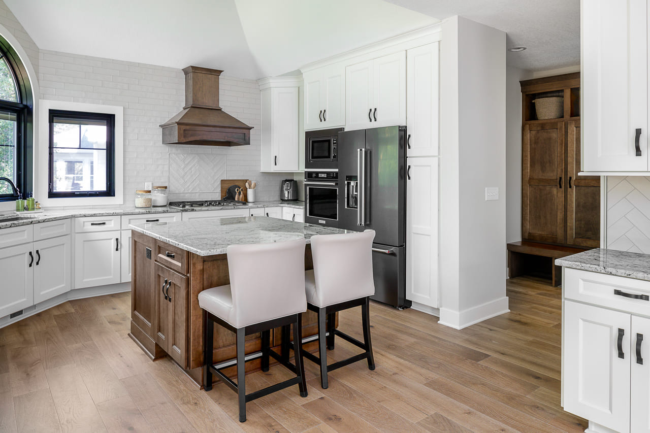 Modern White Kitchen with Island Seating for Two and White Glass Decorative Subway Tile | Compelling Homes Design Build