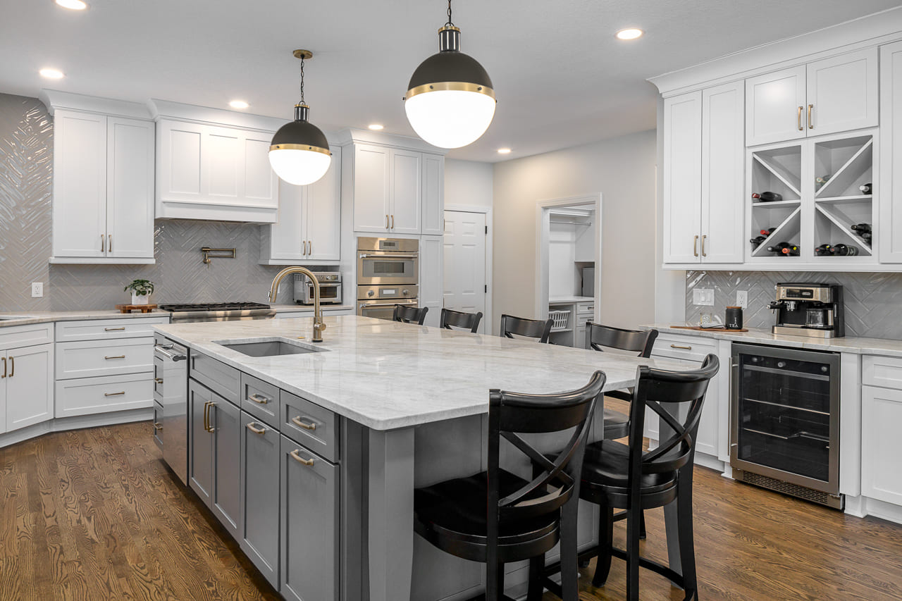 White Cabinetry and Light Grey Cabinets Under Marble Countertop Island | Compelling Homes